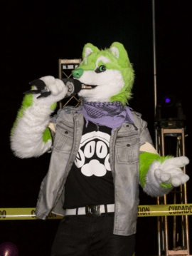 NIIC the Singing Dog performing live on stage in fursuit